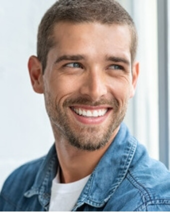 Man looking out window