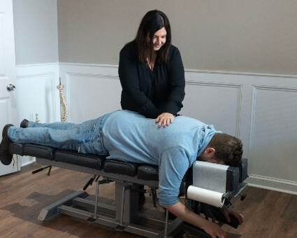 Manchester chiropractor Dr. Lisa adjusting patient's back