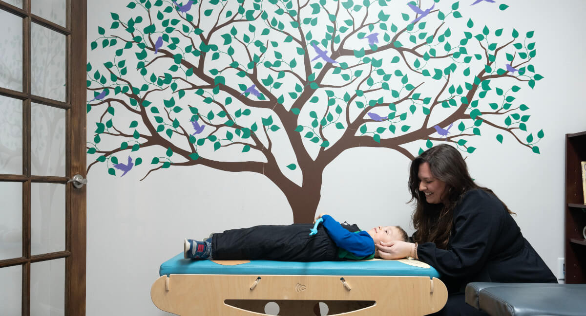 Manchester chiropractor Dr. Tatiana adjusting a pediatric patient