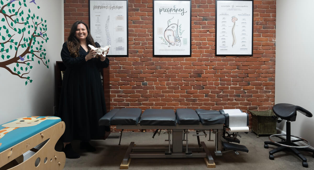 Manchester chiropractor Dr. Tatiana standing in patient treatment room