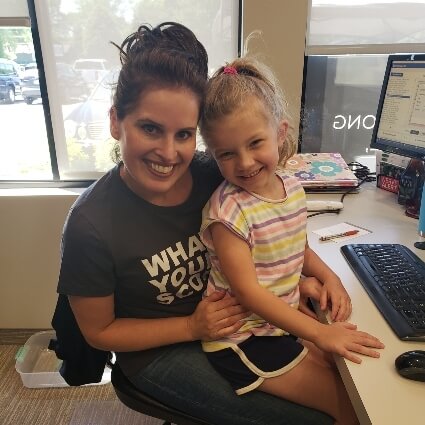 Angela with child at the front desk