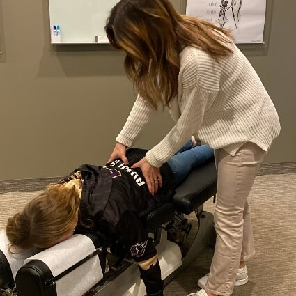 Dr A adjusting patients low back