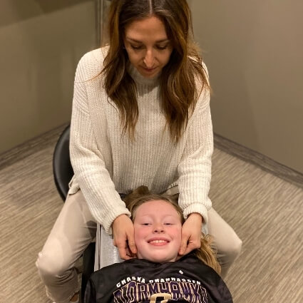 Dr A adjusting girls neck