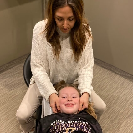 Dr Ashley adjusting kids neck