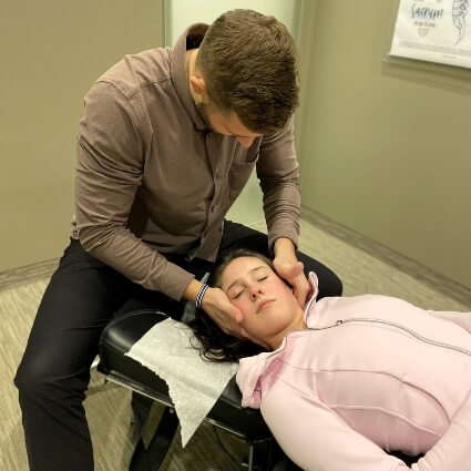 Dr C adjusting womans neck