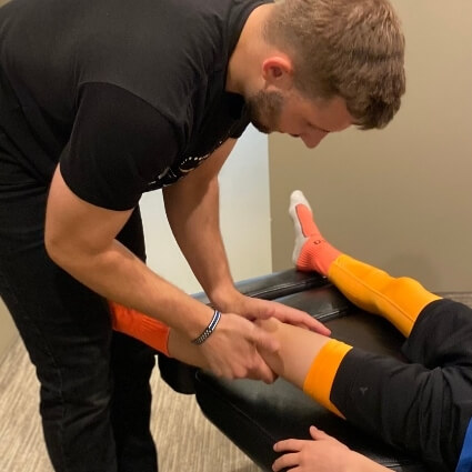 Dr C adjusting boys knee