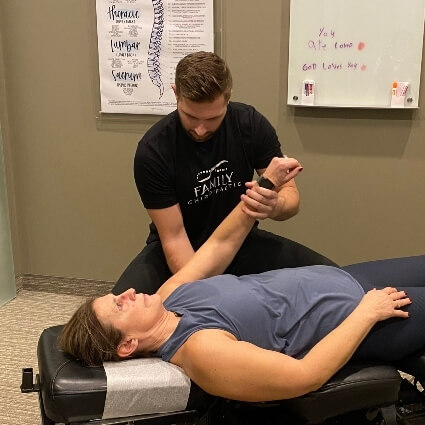 Dr C adjusting pregnant womans arm