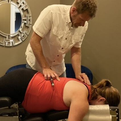 Dr J adjusting pregnant womans back