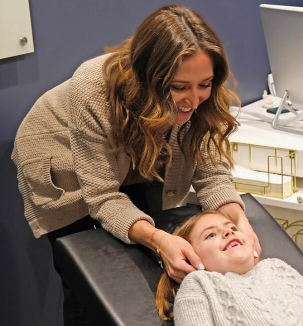 Chiropractor adjusting kid