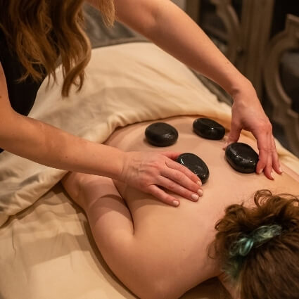 stone massage on patients back
