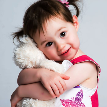 cute child hugging doll