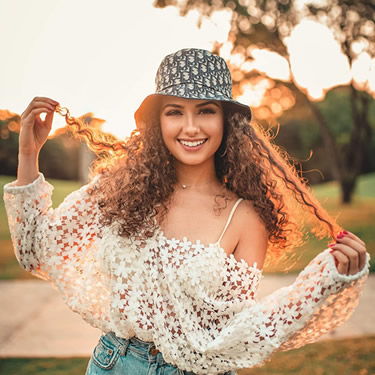 woman smiling confidently beautiful wearing hat