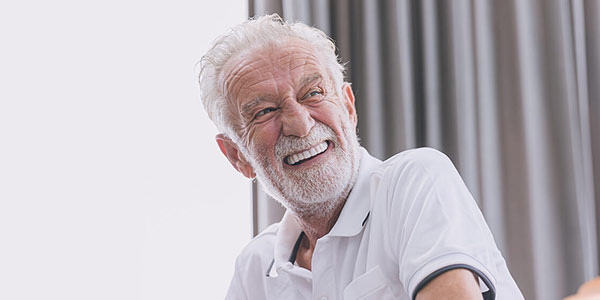 smiling person with grey hair
