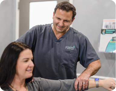 chiropractor adjusting patient arm