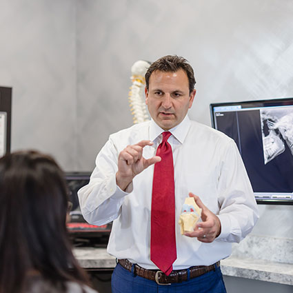 Dr. Dan holding spine model