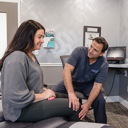 Dr. Dan holding patient's knee