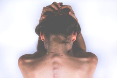 Woman holding head in pain from headache