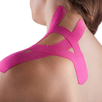 Woman with pink kinesotape on her shoulder