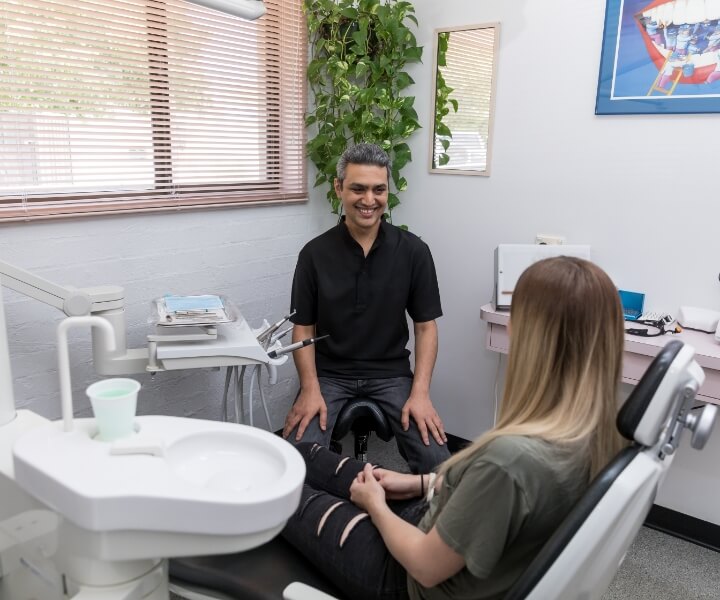 dentist with patient in dental chair