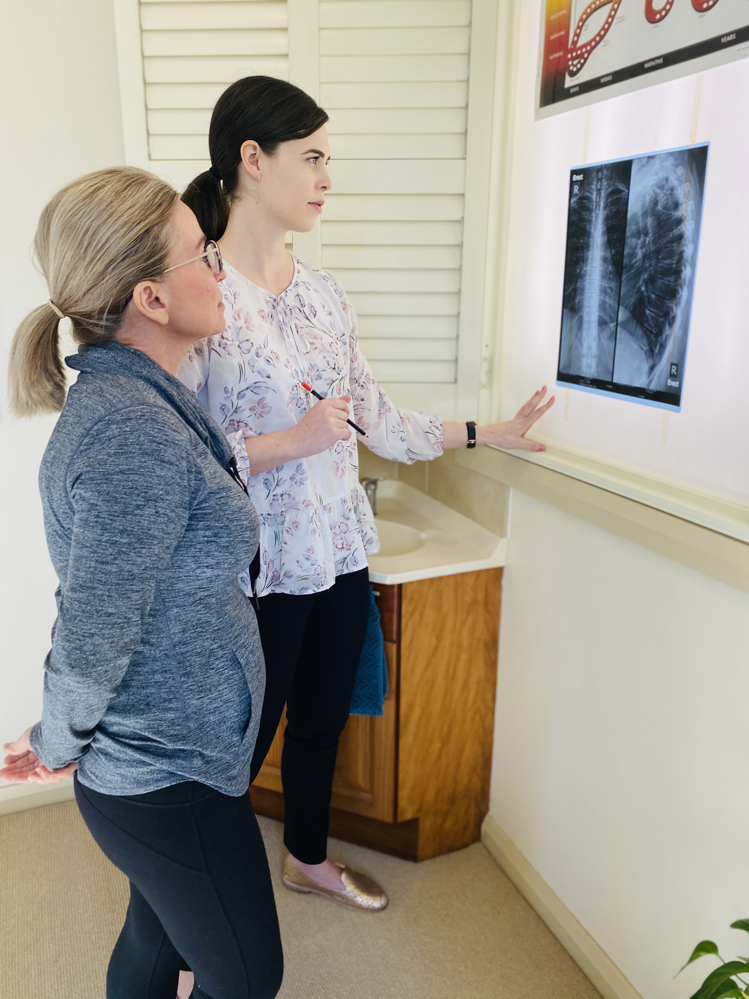 Dr Katelyn explaining a patient's spinal x-rays