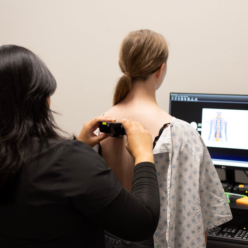 patient having spine scanned