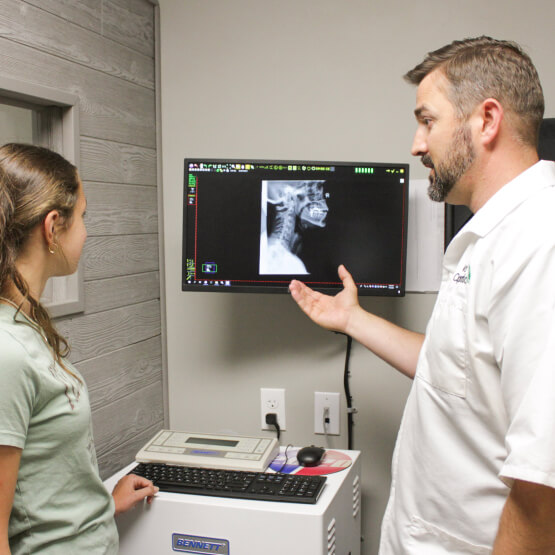 Chiropractor showing x-ray results
