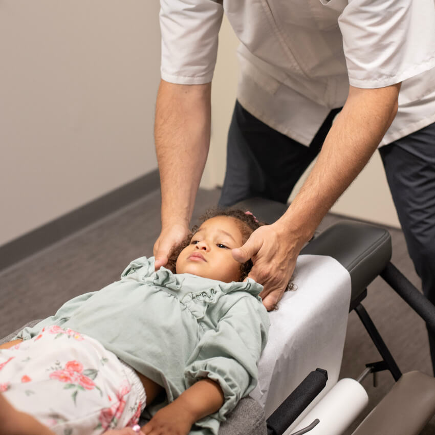 kid having neck adjusted