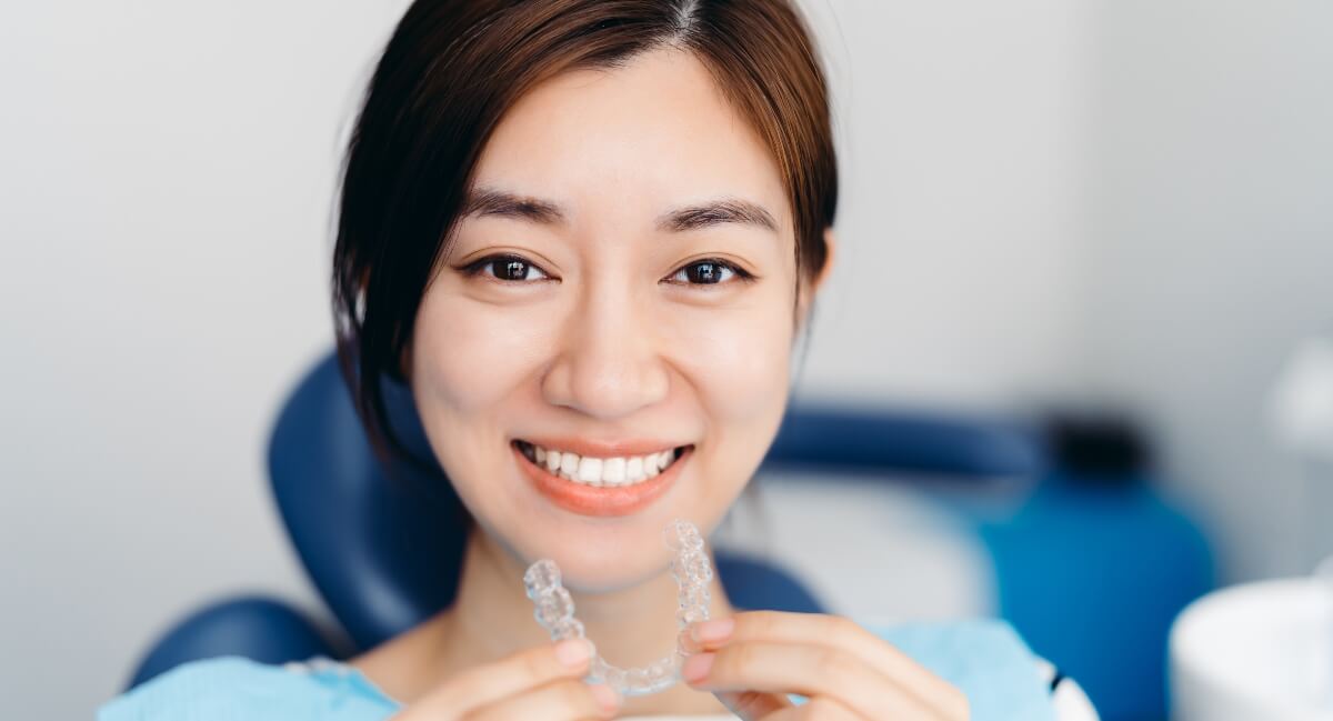 Happy lady holding Invisalign