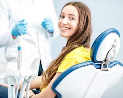 Smiling woman sitting in dental chair