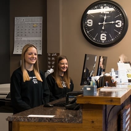 front desk clock and receptionists