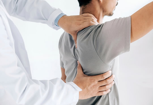 Chiropracor adjusting back shoulder