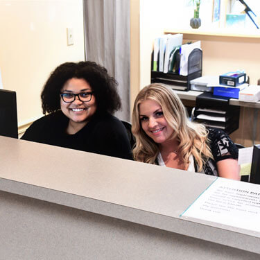 Catherine and Cennadie at front desk
