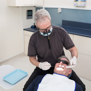 Dr Peter Raymond given dental exam to patient