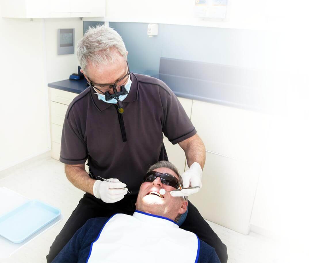 Blockhouse Bay dentist Dr Peter Raymond performing checkup on patient