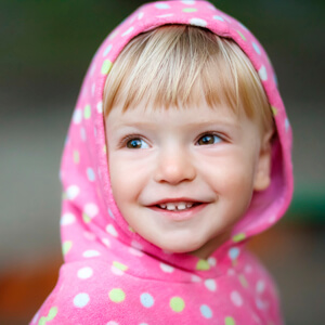 Little girl wearing pink hood