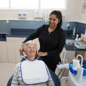 Dental nurse prepping patient for exam