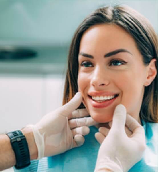 person smiling in dentists office