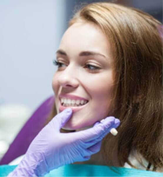 dentist touching persons lip