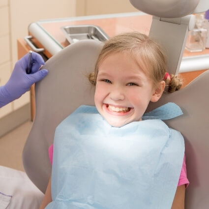 Young girl sitting on dental chair