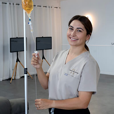 Nurse-smiling-with-IV-bag