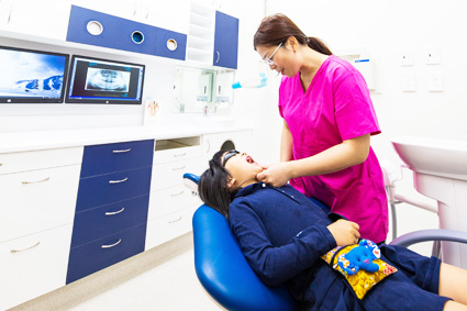 Dr Chong with patient in dental chair