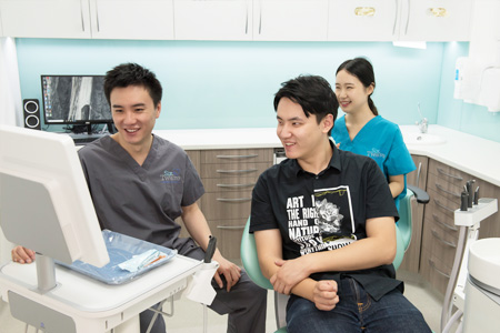 Dr Lam (Dentist) explaining procedure to patient