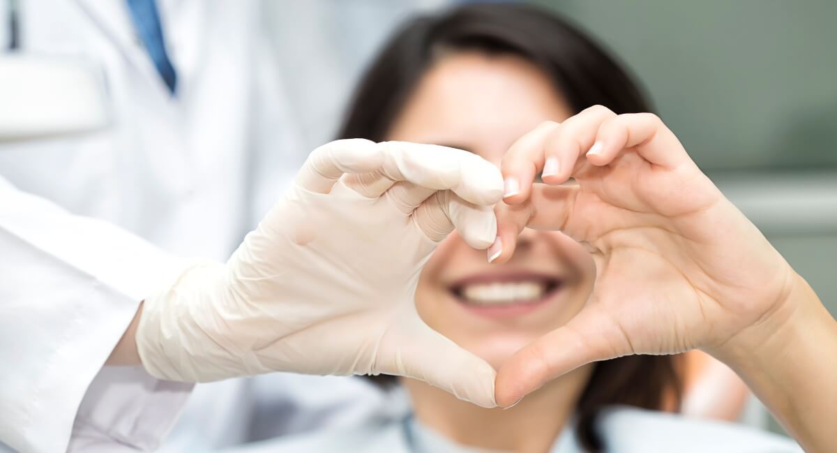 Dentist making heart shape with hands