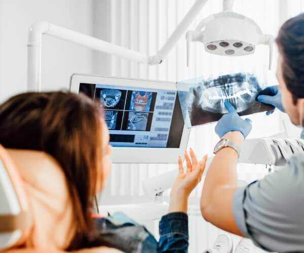 Dentist discussing x-ray with patient