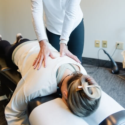 Waterloo chiropractor Dr Catharine adjusting patients back