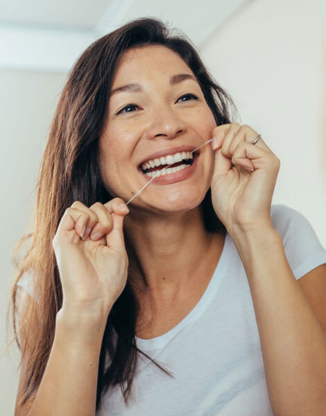 woman flossing teeth