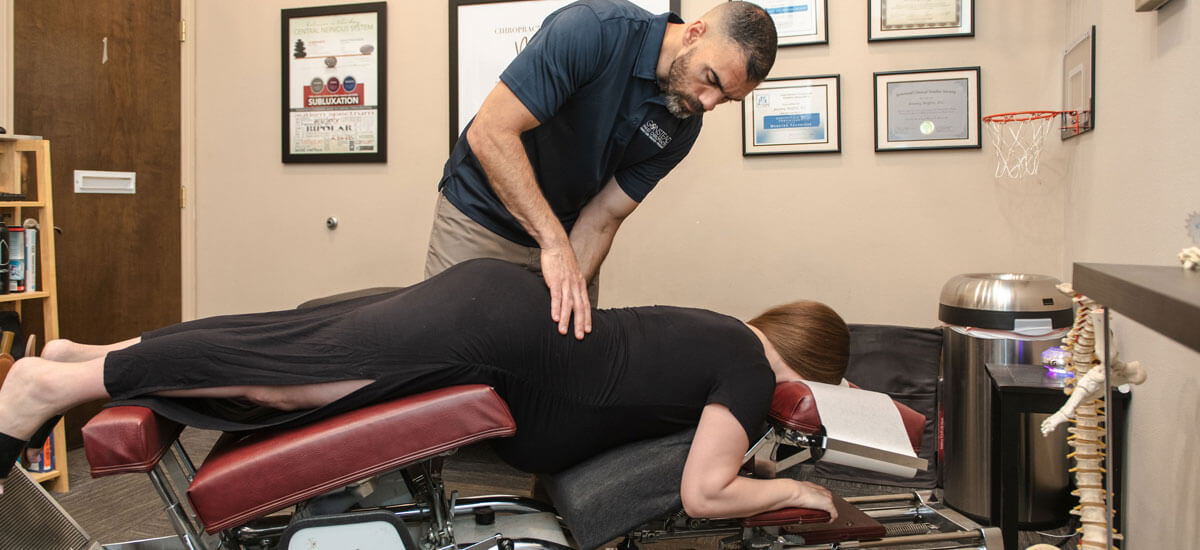 adjusting pregnant woman on table