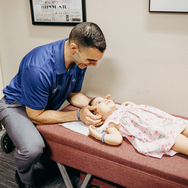 Dr. Jeremy adjusting toddler