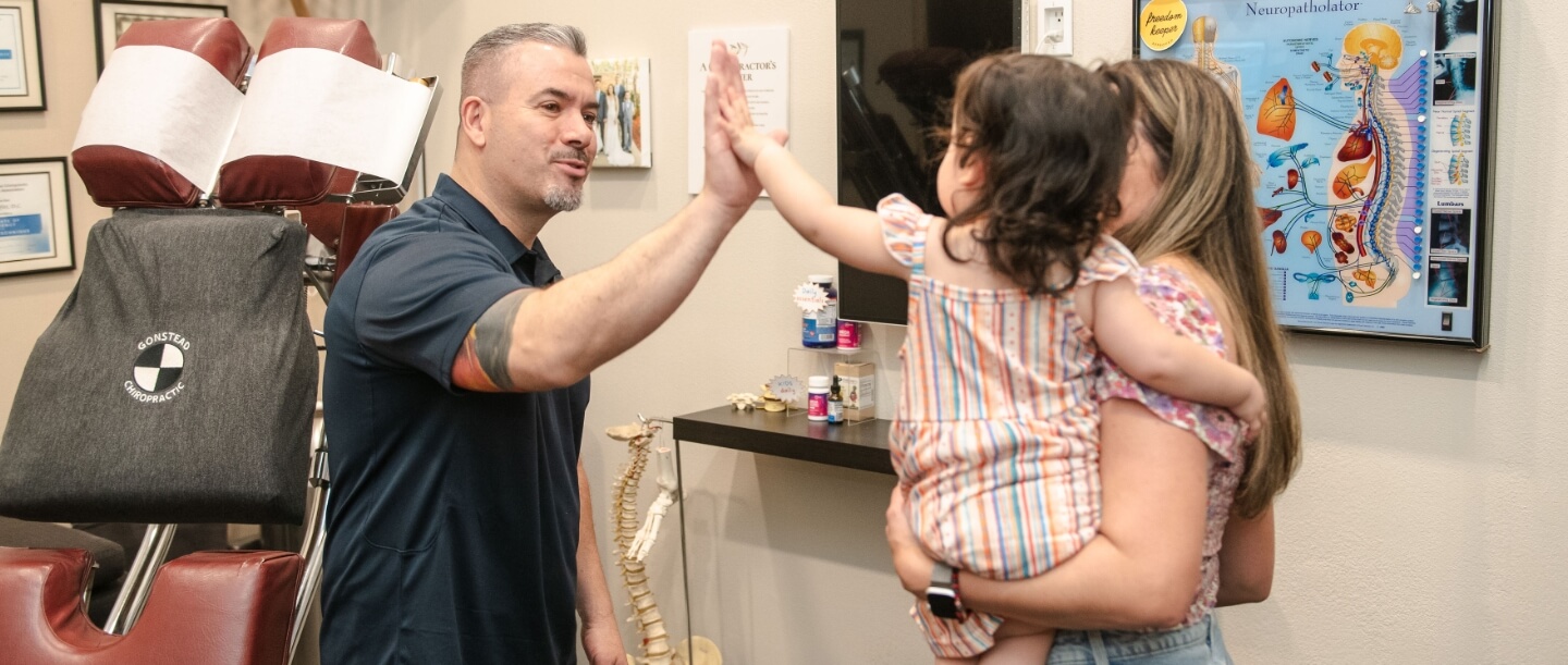 Chiropractor high fiving young girl