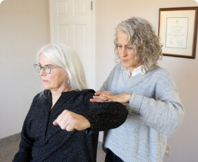 Essence Chiropractic patient having arm examined